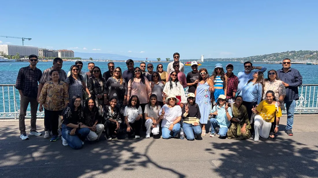 An HCG group of more than forty travellers on a European waterfront promenade
