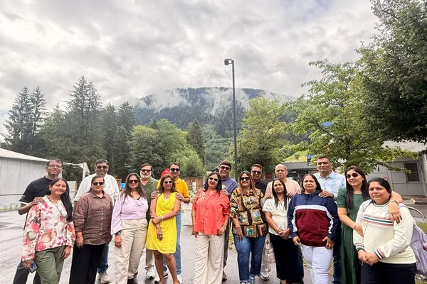An HCG group walking a mountain path in the rain