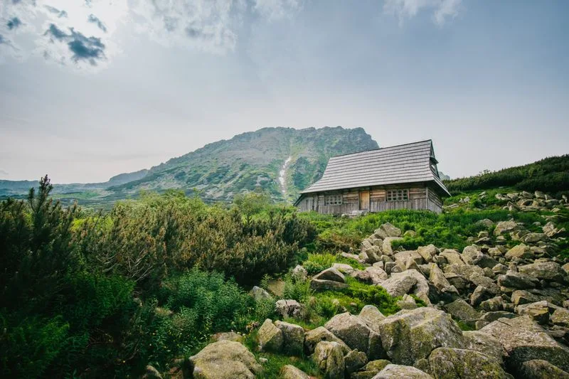 A wooden highland hut among boulders in the Podhale foothills
